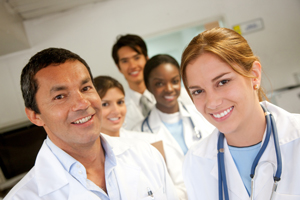 Picture of three female Physicians and two male Physicians.