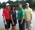 Picture of one female and three male golfers outside smiling. (Wendy Linzee, Greg Wilson, Josh Wilson, and Barry Craig)