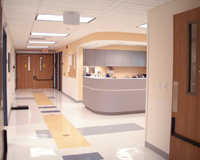 Picture of Hospital floor hallway and a Nurses Work Station.