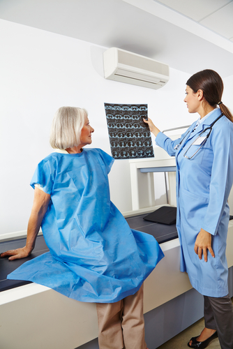 Female provider performing a bone density exam on a female patient.